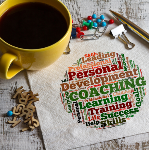 personal development coaching word map alongside cup of coffee